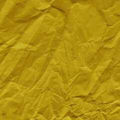 Yellow vintage and old looking crumpled paper background. Retro cardboard texture. Grunge paper for drawing. Ancient book page. Present wrapping.