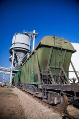 Phosphate fertilizers plant. Railway  loader station or terminal fertilizers. Hopper car train. Green railway carriages.
