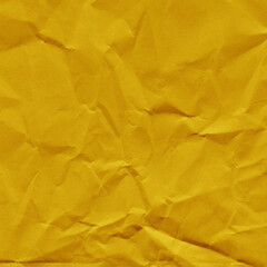 Yellow vintage and old looking crumpled paper background. Retro cardboard texture. Grunge paper for drawing. Ancient book page. Present wrapping.