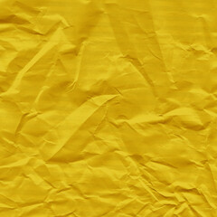 Yellow vintage and old looking crumpled paper background. Retro cardboard texture. Grunge paper for drawing. Ancient book page. Present wrapping.