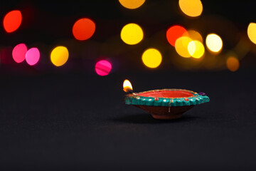 Fototapeta na wymiar Colorful clay diya lamps lit during diwali celebration