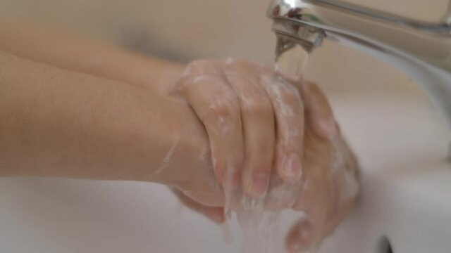 Little Girl Washing Hands With Soap Over Sink in Bathroom. Woman Washing Hands Rubbing With Soap. Child For Corona Virus Prevention, Hygiene to Stop Spreading Coronavirus. Slow Motion.