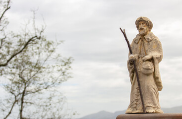Small statue of Saint James on Camino de Santiago. Pilgrimage concept. Main christian saint of...