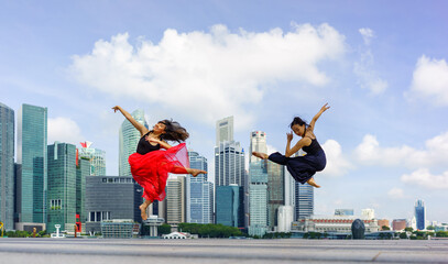 Dancers in front of the Singapore skyline