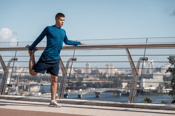 Adult sporty guy making sport training outdoors alone