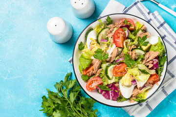 Tuna salad with green leaves, eggs and vegetables.