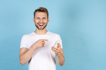 Happy adult man pointing on modern smartphone