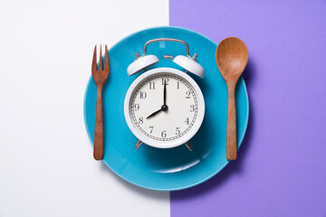 Food clock. Healthy food breakfast concept on white and purple table background