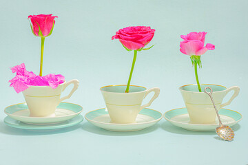 Three cups and saucers with 3 roses