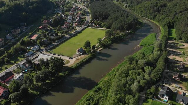Flying over Poprad river in summer. Beskid Mountains, village Rytro, Poland.