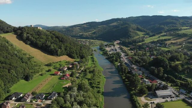 Flying over Poprad river in summer. Beskid Mountains, village Rytro, Poland.