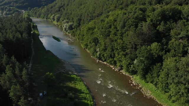 Flying over Poprad river in summer. Beskid Mountains, village Rytro, Poland.