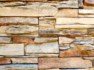 the texture of the wall is made of uneven stones of different sizes of sand and light brown color.....