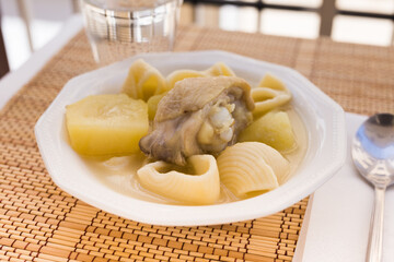 chicken broth soup with chicken, potatoes, and pasta shells
