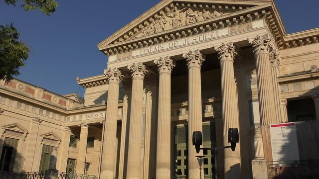 Court house, or Palais de Justice (1846) - imposing neoclassical monument of Nimes city in France. It has a powerful colonnade overlooking Charles-de-Gaulle esplanade.