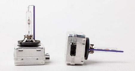 Xenon is a new lamp for automotive headlights on a white background. Gas-discharge lighting devices Xenon is a new lamp for automotive headlights. Used auto parts catalog from junkyard.