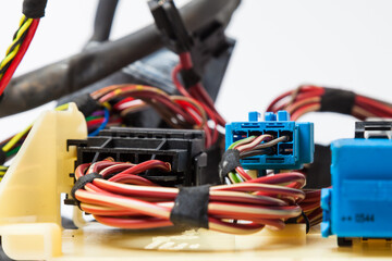 A cable of matted wires of different colors with connectors in the electrical wiring of the car. Internet line in the work of the provider.