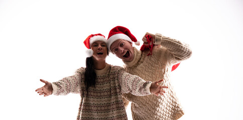 Young couple in Christmas sweaters. Christmas couple. White background. Surprise. 