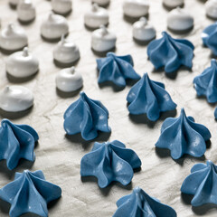 meringue, white and blue meringue on a teflon baking mat