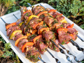 juicy meat on skewers, barbecue, on a white tray