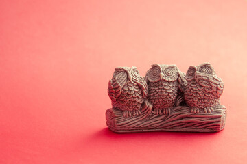 three owls on a branch