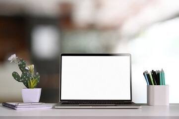 Mock up blank screen computer laptop desktop with modern office background.