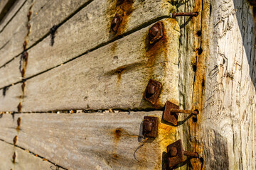 Rusty bolts on wooden groyne