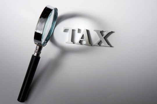 magnifying glass and tax