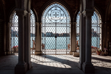 Gate of St. Michele cemetery on sunny day with Venice background
