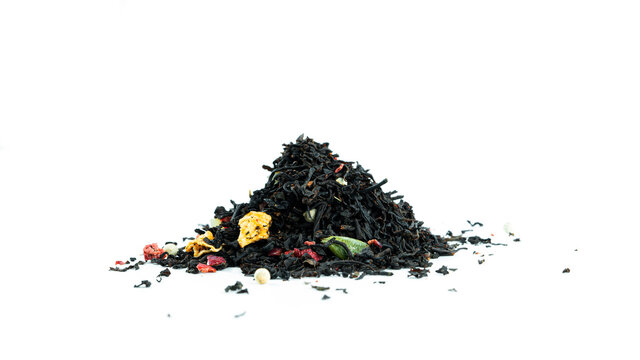 Bunch of black tea leaves with fruits on white background. High quality photo