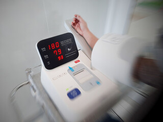 Patients with high blood pressure are measuring the pressure from a monitor. Blood pressure monitor...