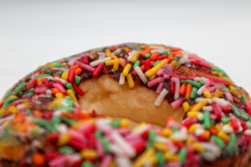 Fototapeta na wymiar macro photo colorful easter donut cake with white isolated