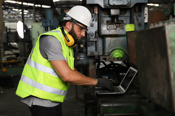 A engineer or technician or worker working with blue print drawing spec about machine part preparing or operate or repair maintenance in factory