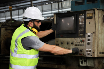 A engineer or technician or worker working with blue print drawing spec about machine part...