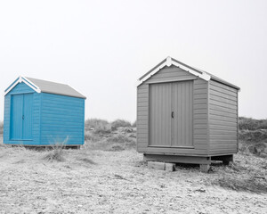 Obraz na płótnie Canvas Findhorn, Scotland - July 2016: Colourful beach huts along the coast at Findhorn Bay in Northern Scotland among the sand dunes