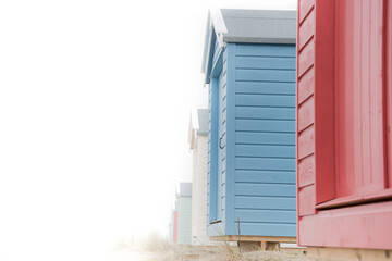 Findhorn, Scotland - July 2016: Colourful beach huts along the coast at Findhorn Bay in Northern Scotland among the sand dunes