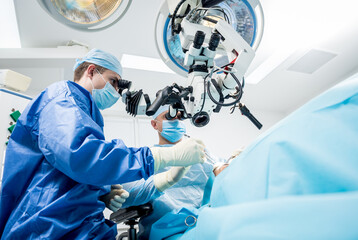 A team of surgeons performing brain surgery to remove a tumor.