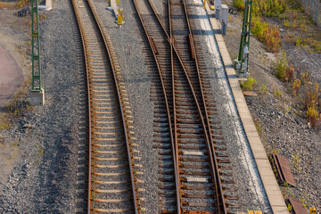 Two railway tracks splitting into three. Viewed from above.
