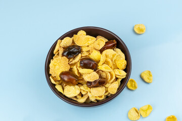 Healthy food cornflakes in a plate close up with dates