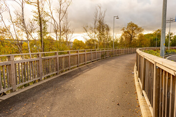 Curved bike path with wooden fencing.