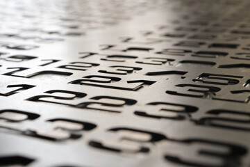 A set of numbers on a plane in the dim light receding into the distance. Numbers in a jumbled set...