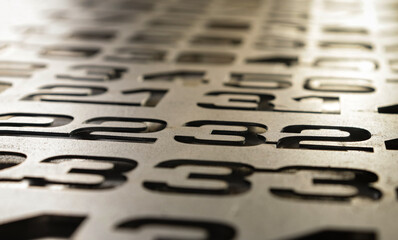A set of numbers on a plane in the dim light receding into the distance. Numbers in a jumbled set...