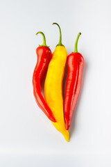 Three peppers on a white background