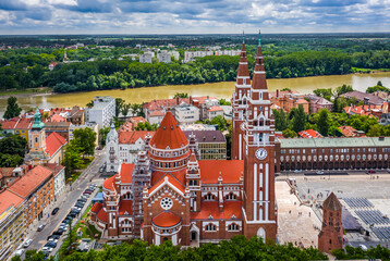 Szeged, Hungary - Aerial view of the Votive Church and Cathedral of Our Lady of Hungary (Szeged Dom) on a sunny summer day with River Tisza and blue sky and clouds at background