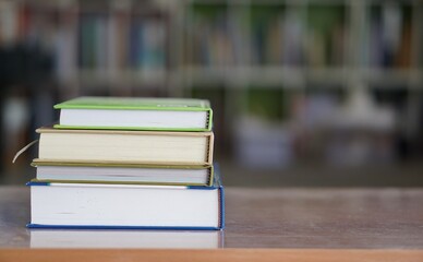 soft focus of the books stacked up on bookshelf background.