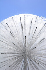 water jets fountain in hot summertime with light reflections on water drops