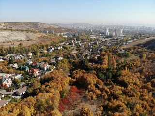 beautiful aeral view of the landscape with city, village and forest in autumn on a Sunny day