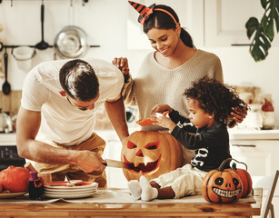 Happy multi ethnic family preparing for Halloween celebration.
