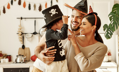 happy multiethnic family mom, dad and son have fun and celebrate Halloween at home.