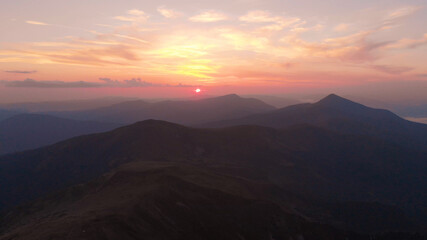 Foggy pink sky and mountains. Sunset in the mountains.